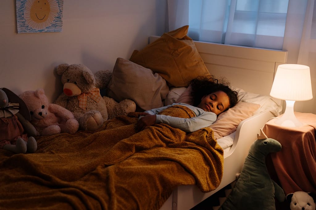 child sleeping in bed