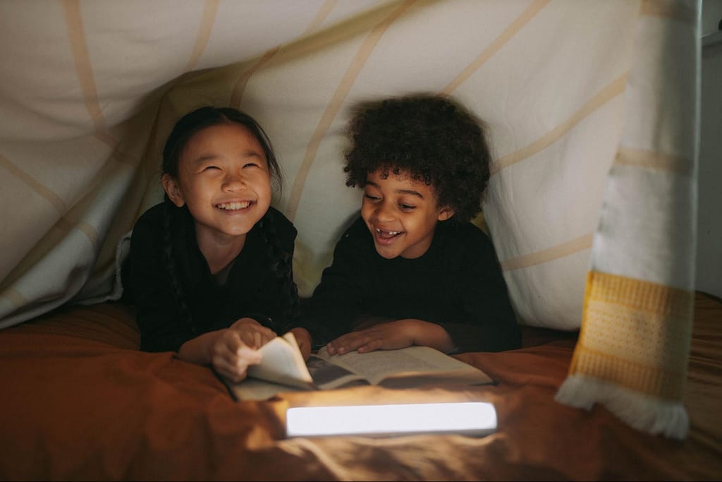 children in bed with light