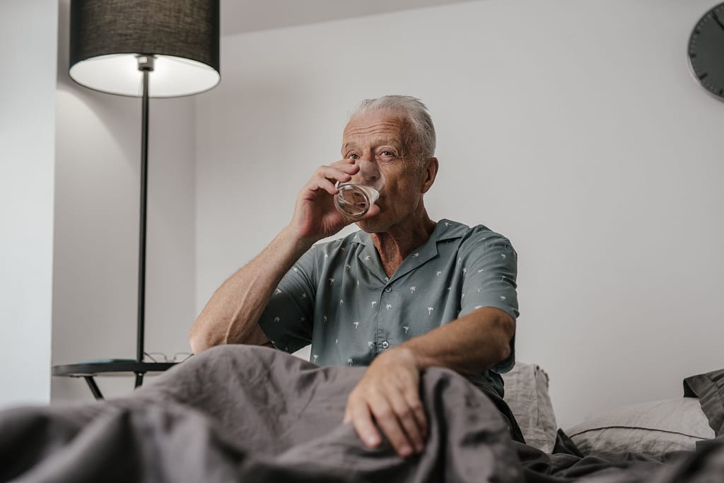 Man drinking water to hydrate for before sleep